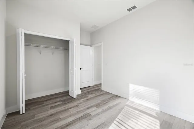 a view of a room with wooden floor