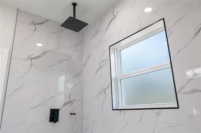 a spacious bathroom with a double vanity sink a mirror and a shower