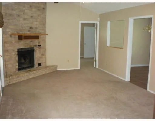 a view of empty room with a fireplace