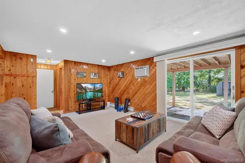 a bedroom with furniture and a large window