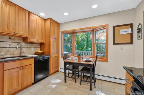 a kitchen with stainless steel appliances granite countertop a stove top oven a sink dishwasher and cabinets with wooden floor