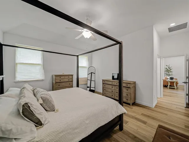 a bedroom with a bed and a table