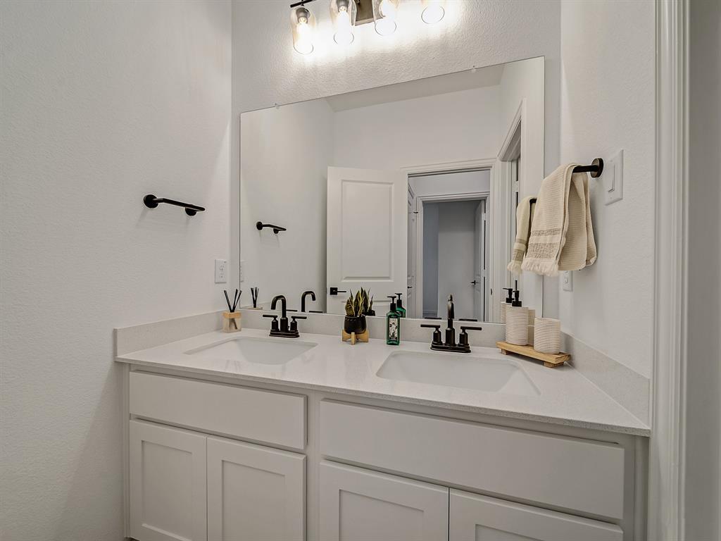 2104 Franklin Road Princeton, TX 75407 - Photo 23 of 36 a bathroom with a sink and a mirror