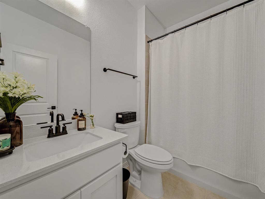 2104 Franklin Road Princeton, TX 75407 - Photo 25 of 36 a bathroom with a sink a toilet and shower