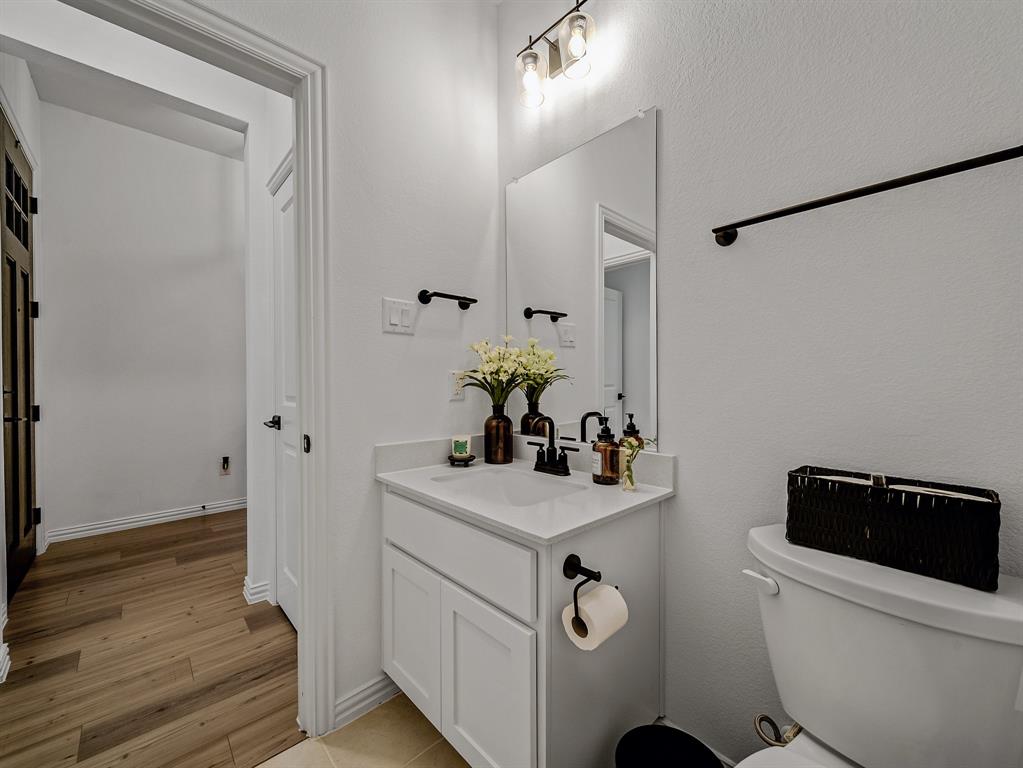 2104 Franklin Road Princeton, TX 75407 - Photo 26 of 36 a bathroom with a sink toilet and shower