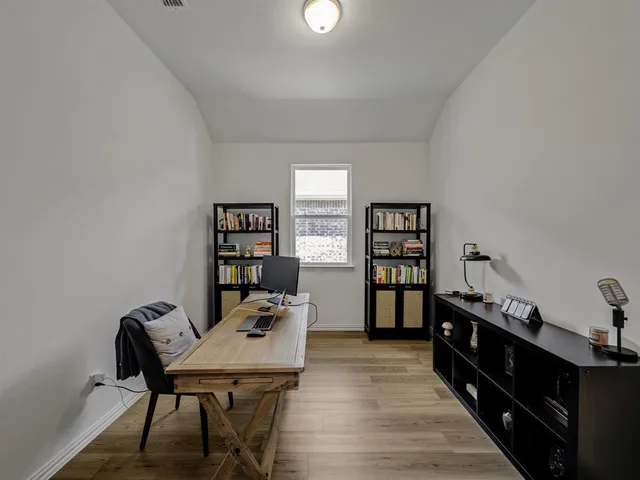 a reading room with furniture and wooden floor