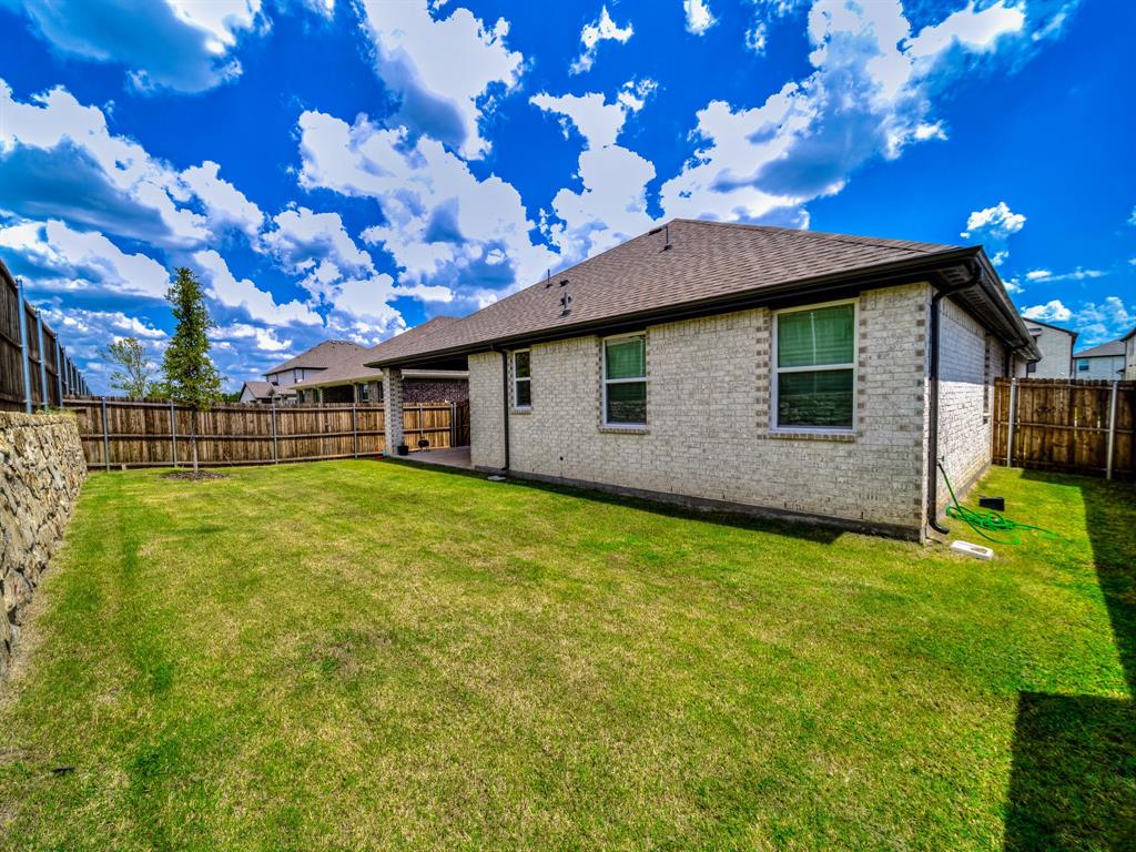 2104 Franklin Road Princeton, TX 75407 - Photo 31 of 36 a view of a backyard with a garden