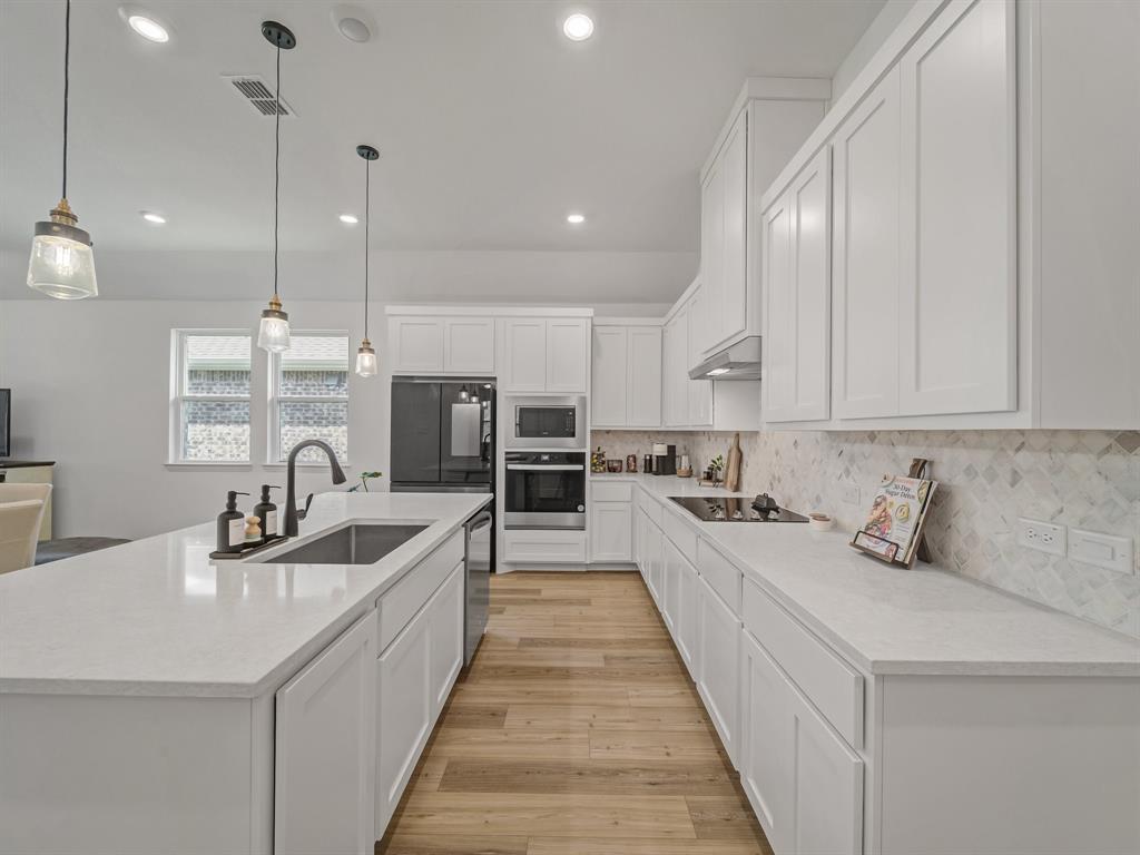 2104 Franklin Road Princeton, TX 75407 - Photo 5 of 36 a kitchen with counter top space a sink stainless steel appliances and cabinets