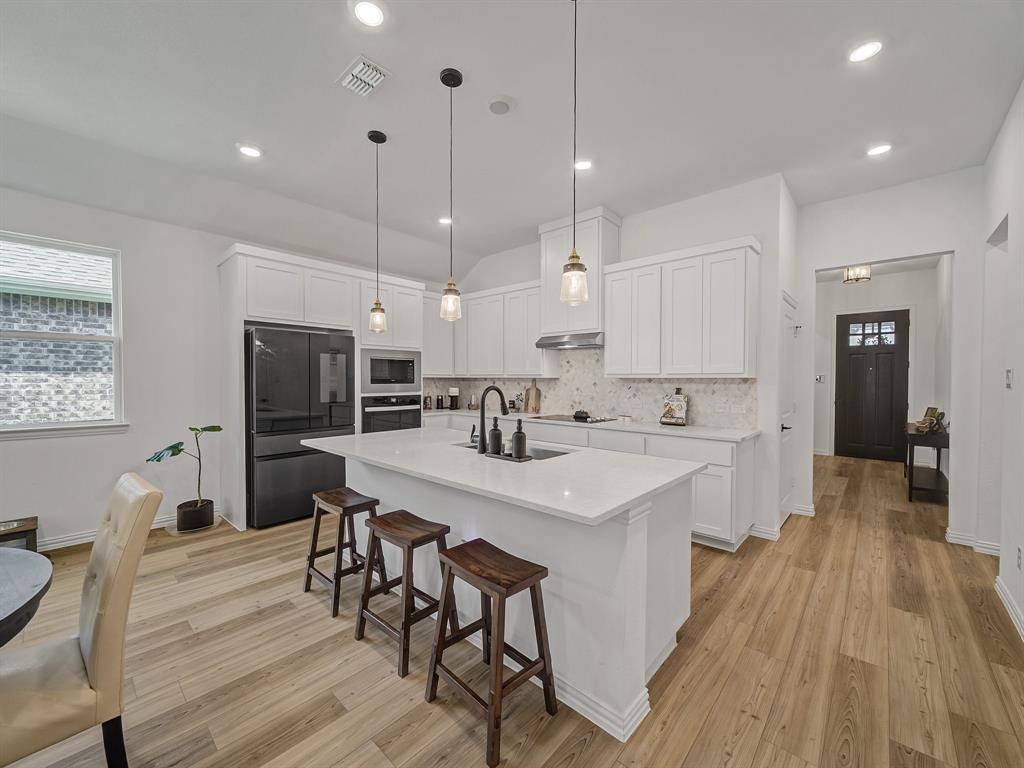 2104 Franklin Road Princeton, TX 75407 - Photo 6 of 36 a large kitchen with a table and chairs in it