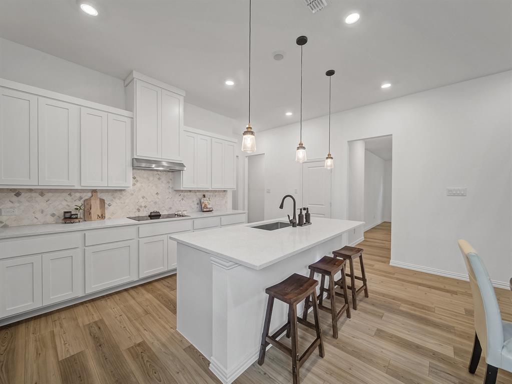 2104 Franklin Road Princeton, TX 75407 - Photo 7 of 36 a kitchen with a table chairs sink and cabinets