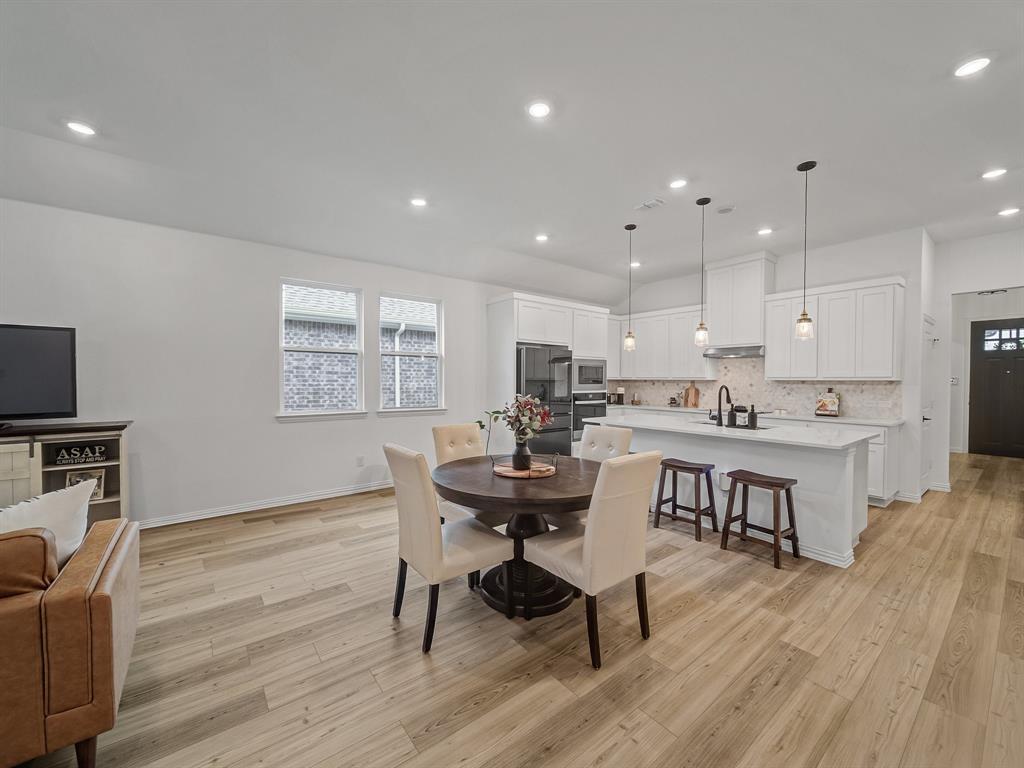 2104 Franklin Road Princeton, TX 75407 - Photo 9 of 36 a kitchen with a table and chairs in it