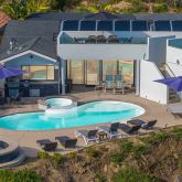 an aerial view of a house with swimming pool garden and patio