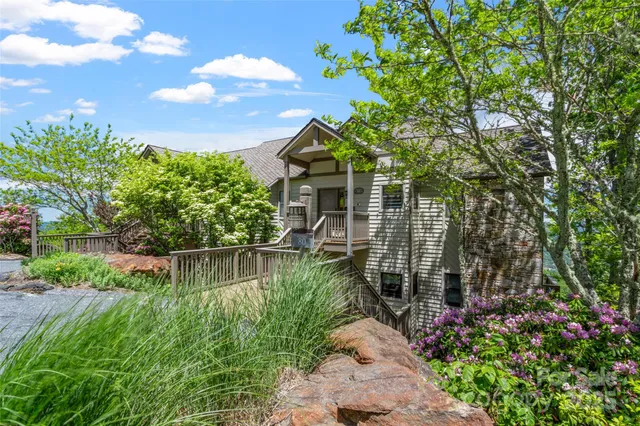 a backyard of a house with lots of green space and fountain
