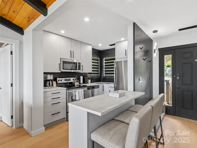 a kitchen with a refrigerator a stove top oven a sink and dishwasher