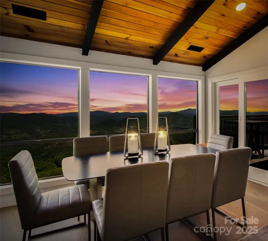 a dining room with furniture a rug and a large window