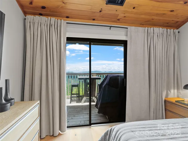 a bedroom with a bed and glass door