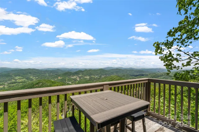 a view of a balcony with wooden floor and city view