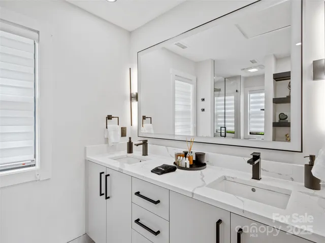 a bathroom with 2 sink and a mirror