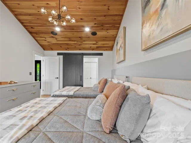 a bedroom with a bed and a chandelier