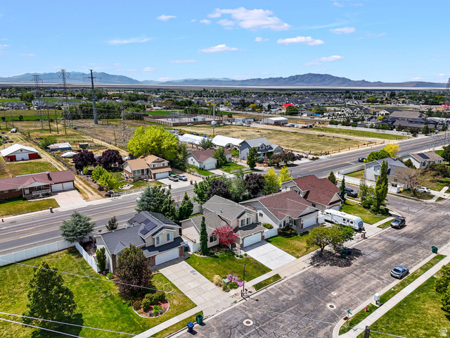 142 East 2675th Street South Clearfield, UT 84015 - Photo 43 of 49 Suburban landscape featuring a residential street, mature landscaping, and a distant mountain range
