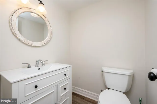 a bathroom with a toilet a sink and a mirror