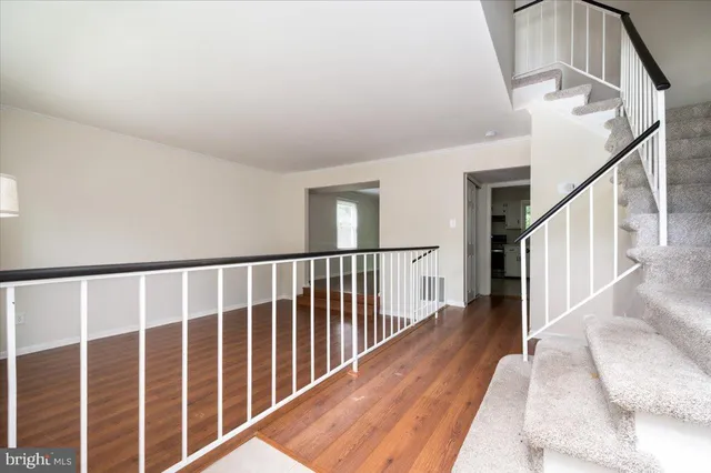 a view of staircase with wooden floor and a window