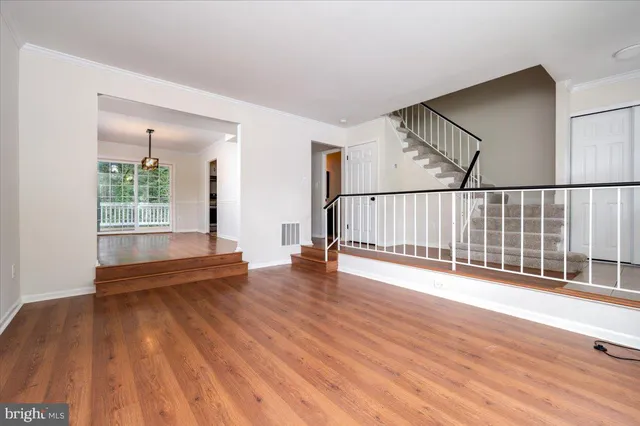 a view of a room with wooden floor windows and entryway