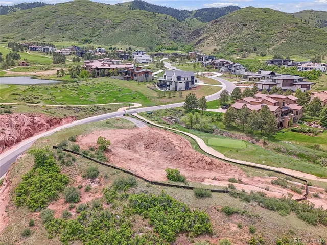 an aerial view of residential houses with outdoor space and street view