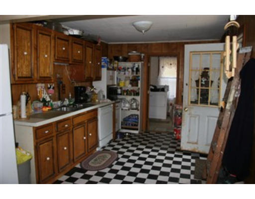 1 Oakham Road North Brookfield, MA 01535 - Photo 3 of 7 a kitchen with a sink a stove and cabinets