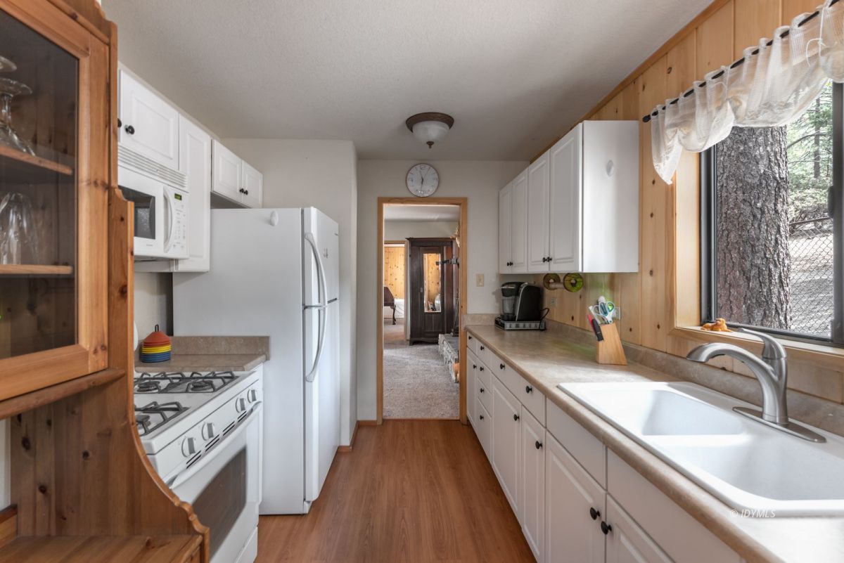 27140 Saunders Meadow Road Idyllwild, CA 92549 - Photo 8 of 25 a kitchen with white cabinets and appliances