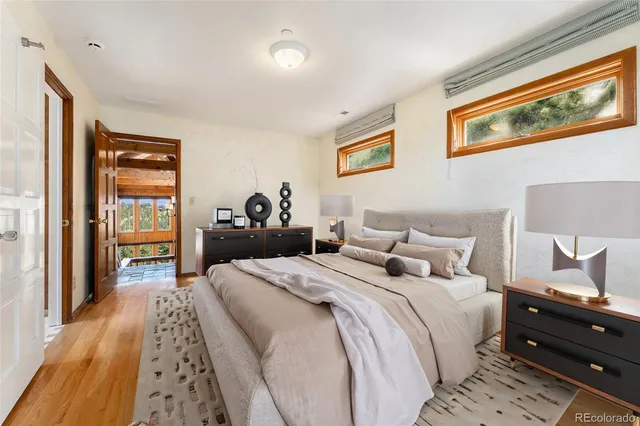 a bedroom with bed and wooden floor