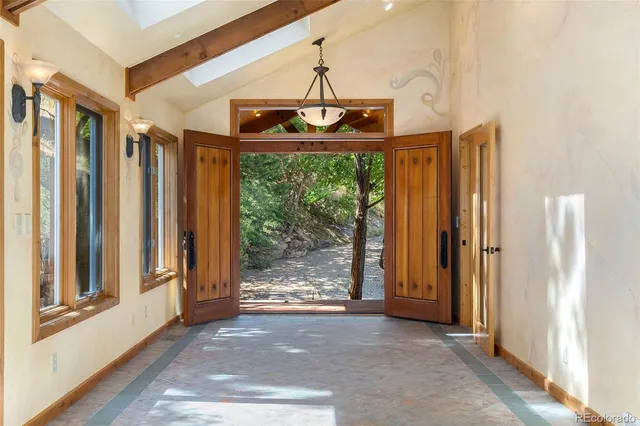 a view of a hallway with wooden floor and door