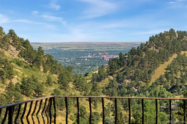 a open kitchen with stainless steel appliances granite countertop a refrigerator a oven and a view of living room