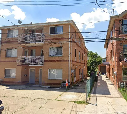a view of a brick house with many windows