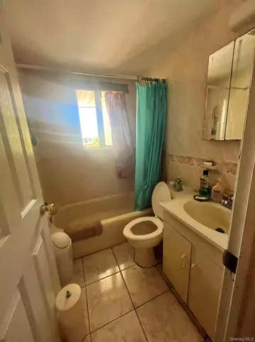 a bathroom with a sink a toilet and bathtub
