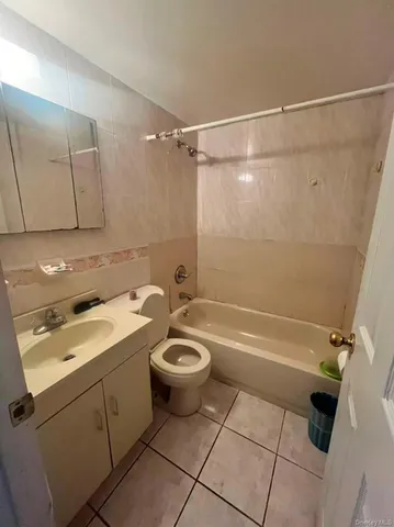 a view of room with window and a flat screen tv