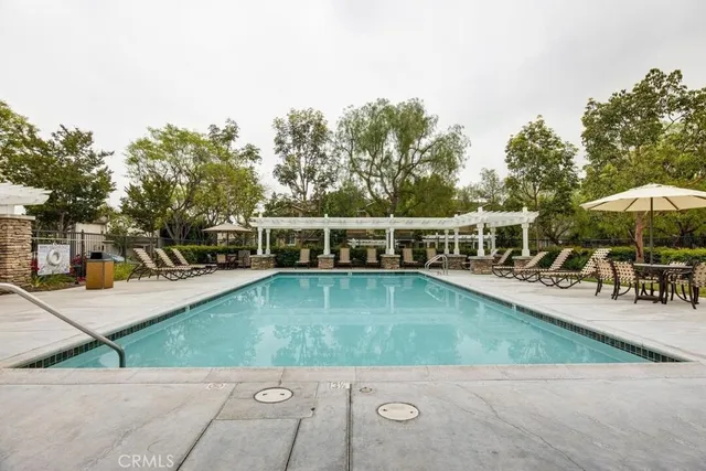 a view of a swimming pool with chairs in patio