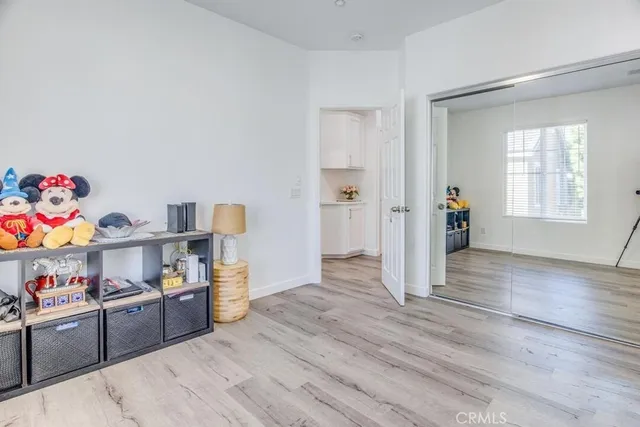 a kitchen with cabinets and wooden floor