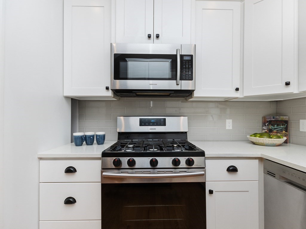 286 Summer Street, Unit 2 Somerville, MA 02144 - Photo 12 of 37 a white stove top oven sitting inside of a kitchen