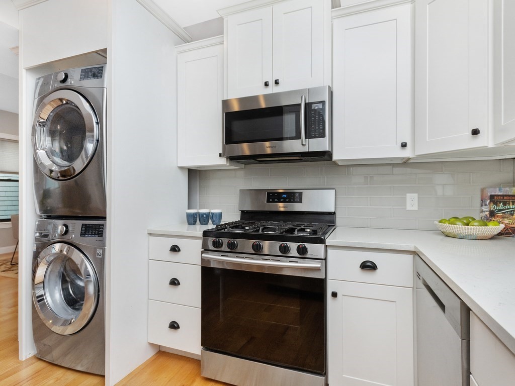 286 Summer Street, Unit 2 Somerville, MA 02144 - Photo 13 of 37 a kitchen with white cabinets and a stove top oven