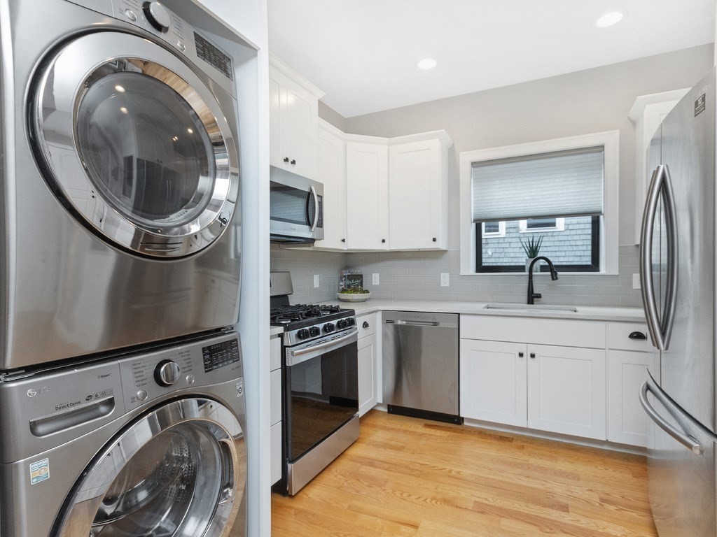 286 Summer Street, Unit 2 Somerville, MA 02144 - Photo 20 of 37 a view of a kitchen with stainless steel appliances granite countertop a sink a stove and a refrigerator