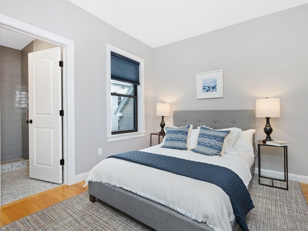 286 Summer Street, Unit 2 Somerville, MA 02144 - Photo 22 of 37 a bedroom with a bed and wooden floor