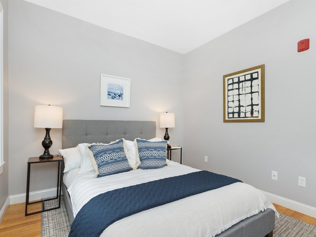 286 Summer Street, Unit 2 Somerville, MA 02144 - Photo 24 of 37 a bedroom with a bed and a lamp