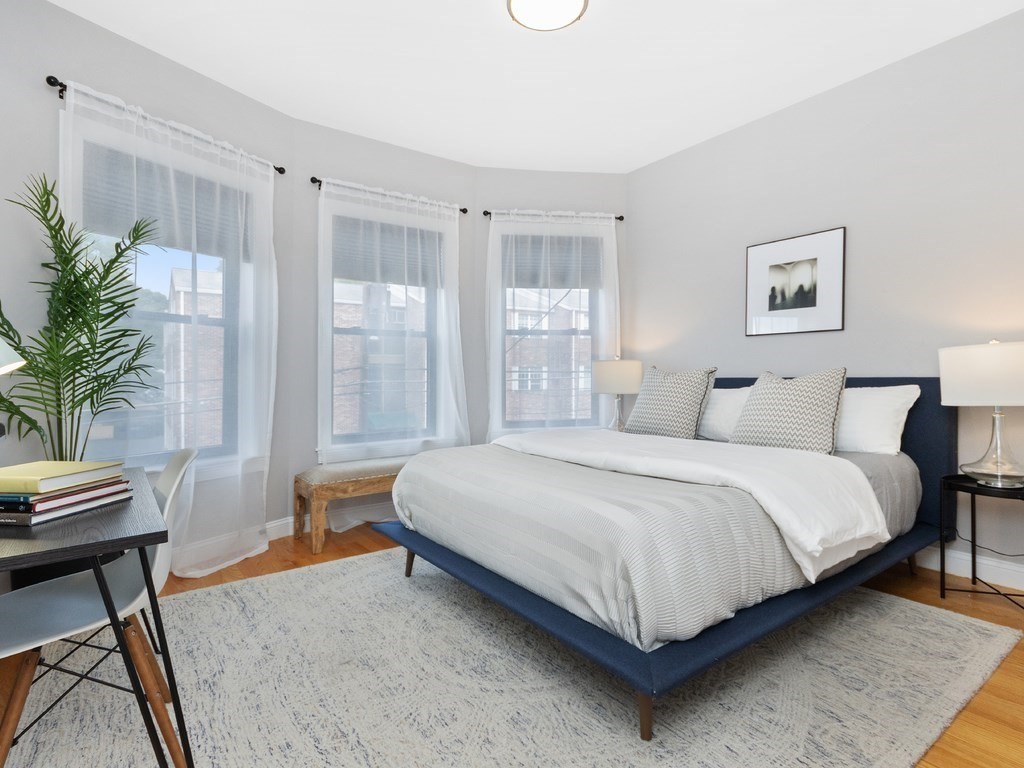 286 Summer Street, Unit 2 Somerville, MA 02144 - Photo 26 of 37 a spacious bedroom with a bed and a window