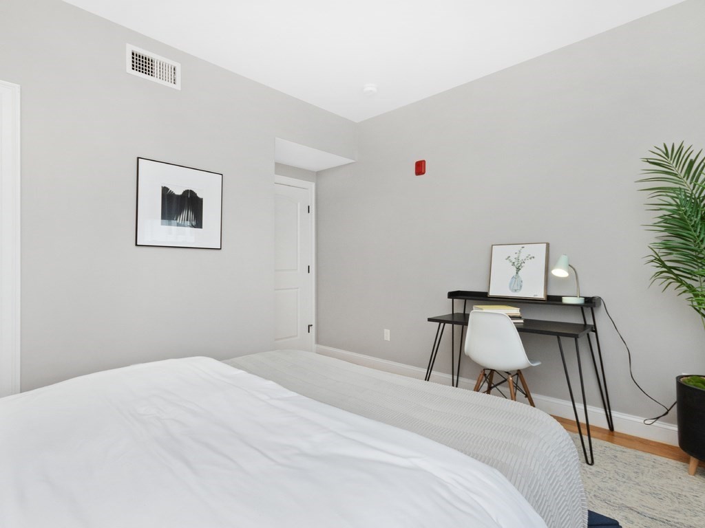 286 Summer Street, Unit 2 Somerville, MA 02144 - Photo 27 of 37 a bedroom with a bed and a table in it