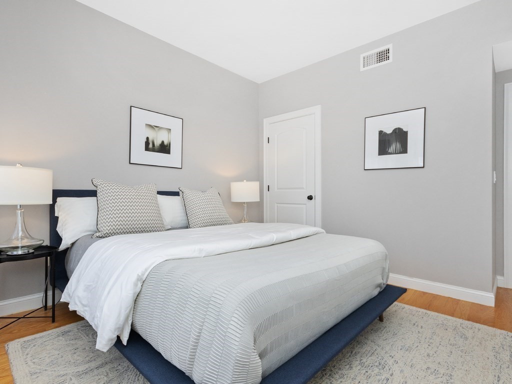 286 Summer Street, Unit 2 Somerville, MA 02144 - Photo 28 of 37 a bedroom with bed and painting on the wall