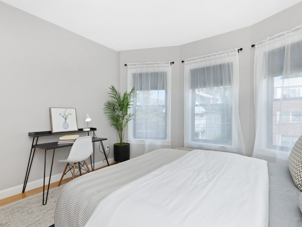 286 Summer Street, Unit 2 Somerville, MA 02144 - Photo 29 of 37 a bedroom with a bed and wooden table