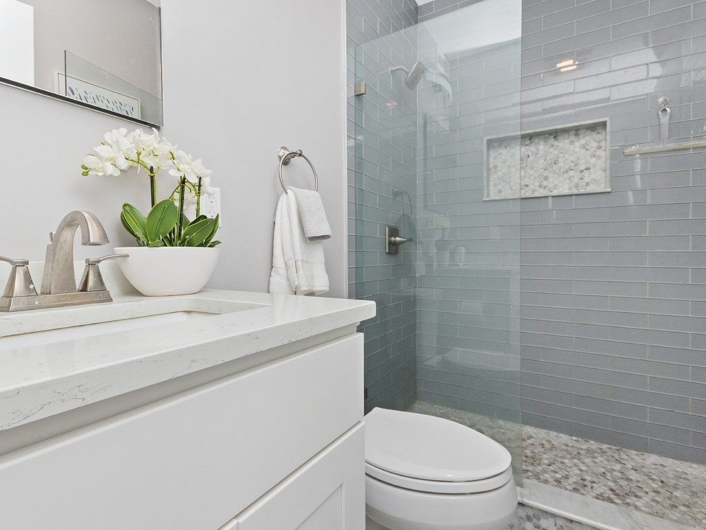 286 Summer Street, Unit 2 Somerville, MA 02144 - Photo 31 of 37 a bathroom with a white sink a toilet and shower