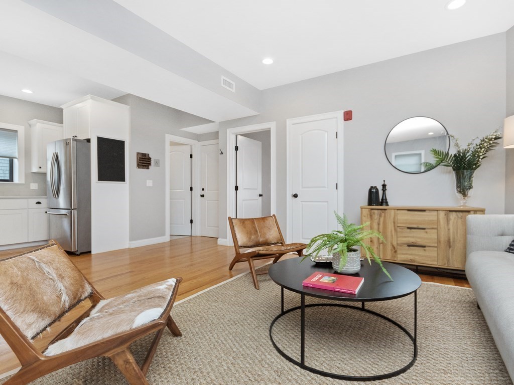 286 Summer Street, Unit 2 Somerville, MA 02144 - Photo 6 of 37 a living room with furniture a refrigerator and a table