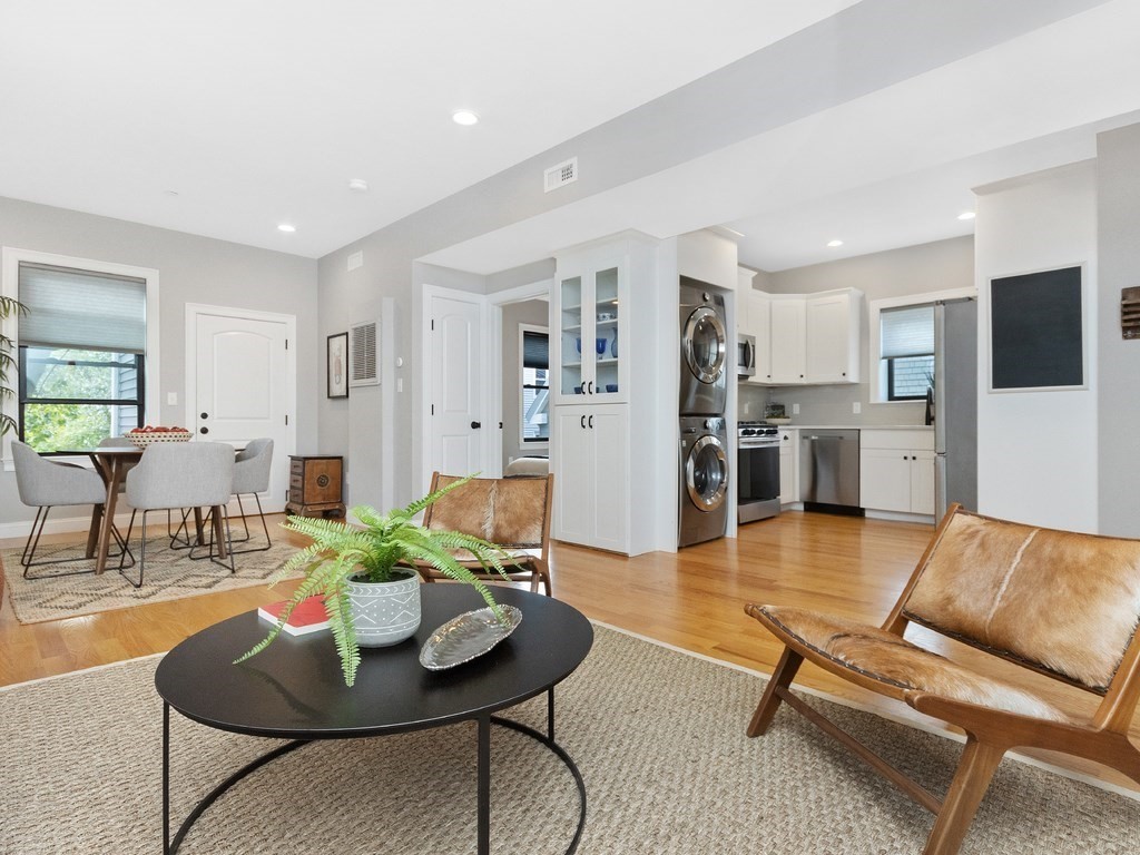 286 Summer Street, Unit 2 Somerville, MA 02144 - Photo 7 of 37 a living room with furniture and a kitchen view